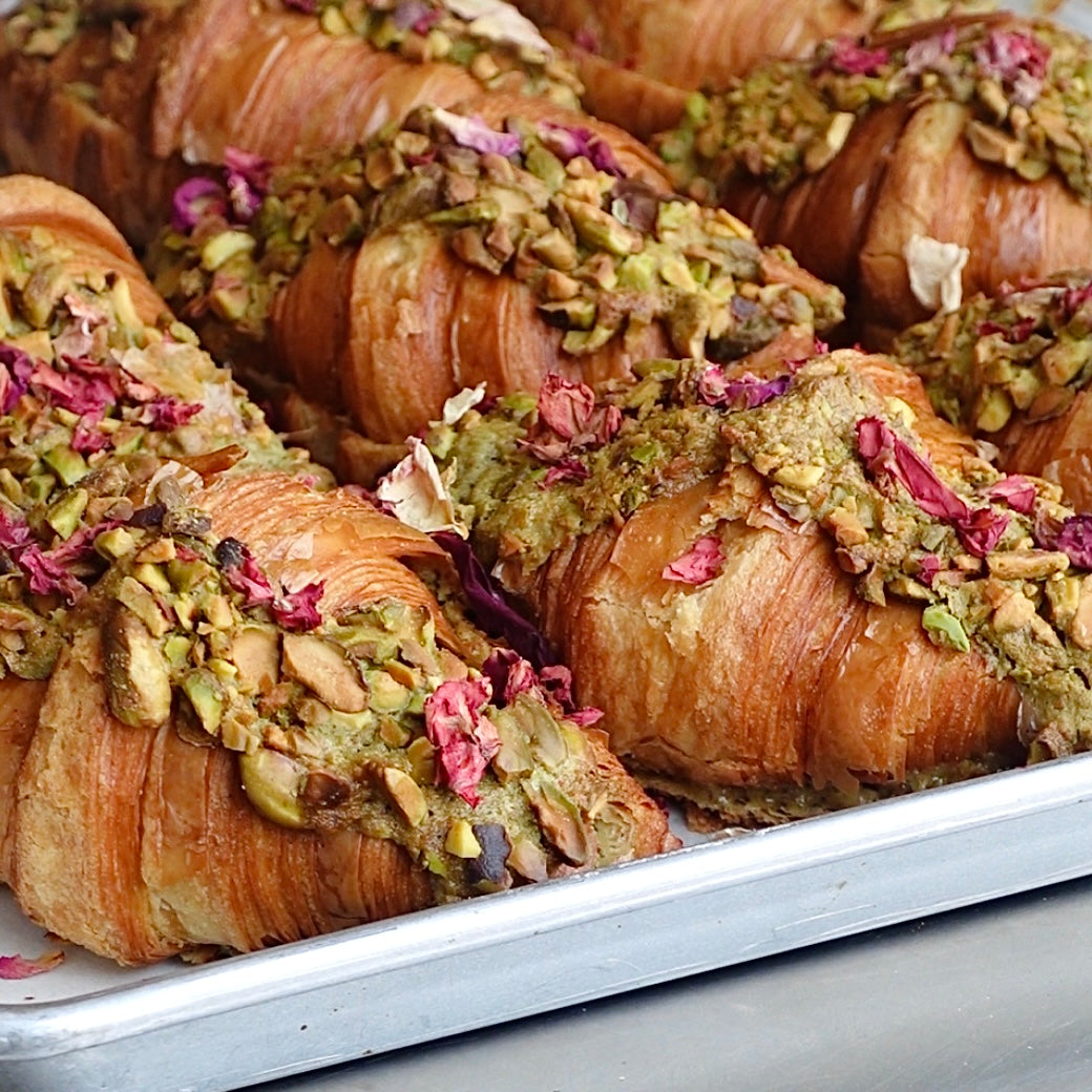 Pistachio Rose Croissant with pistachio and edible flower topping